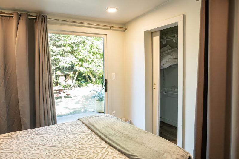 Glass door from bedroom 2 opening to the woods